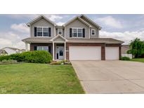 Charming two-story home with a manicured lawn, brick accents, and a spacious three-car garage at 951 Gondola Run, Greenfield, IN 46140