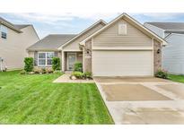 Charming single-story home featuring a manicured lawn, attached garage, and appealing curb appeal at 10731 Jimmy Lake Dr, Indianapolis, IN 46239