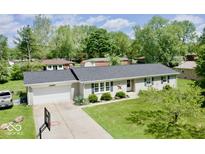 Charming single-story home with well-maintained lawn, front garden, and attached garage at 12144 Trolley Rd, Indianapolis, IN 46236