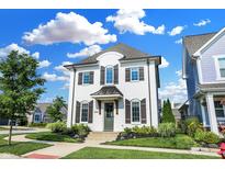 Charming two-story home with a white painted brick exterior, a beautiful yard, and meticulous landscaping at 15116 Fenchurch Dr, Westfield, IN 46074