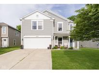 Charming two-story home featuring a two-car garage and a cozy front porch with seating area at 2258 Bridlewood Dr, Franklin, IN 46131