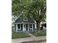 Charming single-story home with a fenced yard and a mature tree at 23 S Holmes Ave, Indianapolis, IN 46222