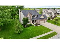 Beautiful two-story home with a well-manicured lawn, lush landscaping and charming brick and vinyl facade at 3251 Amber Way, Bargersville, IN 46106