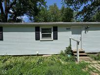 Charming home featuring white siding, black shutters, and a welcoming front entrance at 3403 Coffey St, Indianapolis, IN 46217