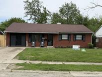Charming brick ranch home with a well-maintained lawn and black shutters at 3417 N Sadlier Dr, Indianapolis, IN 46226