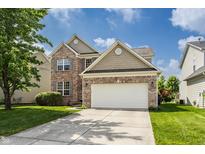 Beautiful two-story brick home with manicured lawn, two-car garage, and blue skies at 3419 Burlingame Blvd, Carmel, IN 46074