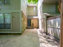 Charming front entrance featuring stone accents, covered entry, and a well-maintained walkway at 4268 Foxglove Trce, Indianapolis, IN 46237
