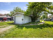 Detached one-car garage with gravel driveway and tree at 4625 N Sadlier Dr, Indianapolis, IN 46226