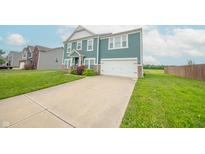 Charming two-story home with blue siding and a spacious driveway at 4712 Clairmont Dr, Columbus, IN 47203