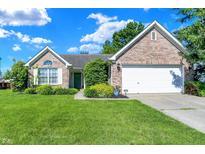 Charming single-story brick home featuring a well-manicured lawn and attached two car garage at 4824 Eagles Watch Ln, Indianapolis, IN 46254