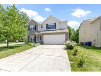 Charming two-story home featuring a two-car garage, well-manicured lawn, and inviting curb appeal at 5145 Greenside Dr, Indianapolis, IN 46235