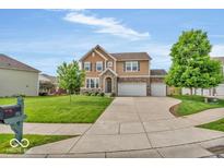 Inviting two-story home featuring a manicured lawn, neutral colors, and an attached two-car garage at 532 Amersham Ct, Avon, IN 46123