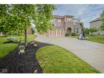 Charming two-story home with a well-manicured front yard and three-car garage at 548 Gosford Ct, Westfield, IN 46074