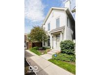 Charming two-story home with well-manicured landscaping, inviting entrance, and plenty of natural light at 654 N Senate Ave, Indianapolis, IN 46202