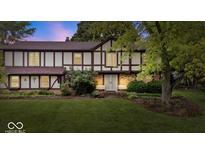 Charming two-story home with Tudor-style accents, lush lawn, and mature trees at 659 Carson Ct, Carmel, IN 46033