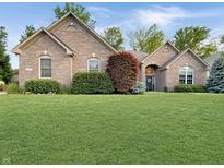 Charming brick home with a well-manicured lawn and mature landscaping at 6693 W May Apple Dr, McCordsville, IN 46055