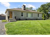 Charming single-story home with a stone facade and well-maintained front lawn at 909 E Markwood Ave, Indianapolis, IN 46227