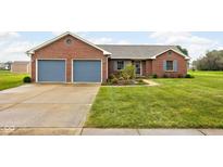 Charming brick home with a well-manicured lawn and a two-car garage and light blue shutters at 9159 E County Road 400 N, Brownsburg, IN 46112