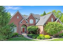 Attractive brick home boasts detailed landscaping and a cozy, covered front entryway at 10390 Tremont Dr, Fishers, IN 46037