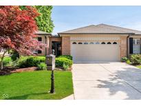 Charming single-story home with brick accents, manicured lawn, and an attached two-car garage at 1045 Millwood Ct, Indianapolis, IN 46260