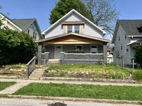 Charming two-story home with a welcoming front porch and original architectural details at 1153 Dawson St, Indianapolis, IN 46203