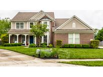 Charming two-story home with brick and siding, covered porch, well-manicured lawn, and a blue front door at 11674 Timken Ct, Fishers, IN 46037