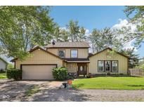 Charming two-story home with well-maintained lawn and inviting front porch at 11733 East 21St St, Indianapolis, IN 46229