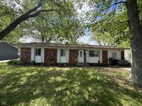 Charming single-story brick home with a well-maintained lawn and inviting front entrance at 2015 Rosewood Dr, Anderson, IN 46011