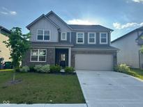 Beautiful two-story home with brick and siding, lush lawn, and a two-car garage at 2263 S Carlota Dr, New Palestine, IN 46163
