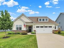 Charming one-story home with a well-manicured lawn, beautiful landscaping, and an attached two-car garage at 247 Verdant Dr, Cicero, IN 46034