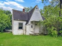 Charming cottage-style home with a quaint front porch and lush green lawn at 2606 Raible Ave, Anderson, IN 46011