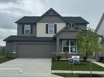 Charming two-story home featuring a two-car garage, landscaped yard, and modern architectural details at 2693 Penn Ave, Plainfield, IN 46168
