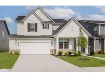 Charming two-story home with white siding, a two car garage, and well-maintained landscaping at 2705 Penn Ave, Plainfield, IN 46168