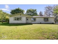 Charming single-story home featuring a well-maintained lawn and inviting facade at 305 N 1100 E, Zionsville, IN 46077