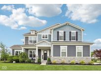 Beautiful two-story home with a manicured lawn and attractive landscaping at 3316 Shelborne Woods Pkwy, Carmel, IN 46032