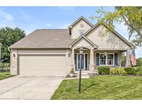 Charming two-story home with a well-manicured lawn, brick accents, and an attached two-car garage at 4818 Arabian Run, Indianapolis, IN 46228