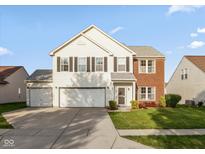 Charming two-story home with a two-car garage and well-maintained front lawn at 5891 Mimosa Dr, Indianapolis, IN 46234
