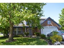Charming two-story home featuring brick accents, inviting front porch, and well-manicured lawn at 6056 Blackley Ct, Indianapolis, IN 46254