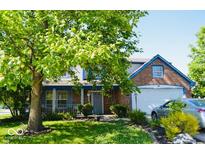 Charming two-story home with brick accents, a covered porch, and a well-manicured lawn at 6056 Blackley Ct, Indianapolis, IN 46254