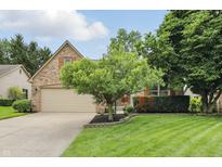 Charming single-Gathering home with a two-car garage, well-maintained lawn and mature trees at 7329 Pymbroke Dr, Fishers, IN 46038