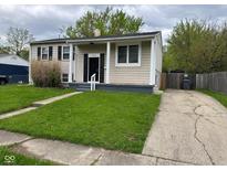 Charming home featuring a well-manicured lawn, neutral siding, and classic black shutters at 7514 Ruskin Pl, Indianapolis, IN 46226
