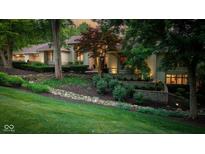 Charming home with professionally landscaped front yard and retaining wall at 7624 William Penn Pl, Indianapolis, IN 46256