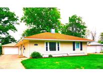 Charming single-story home with a well-maintained lawn and detached garage at 8357 Harrison Dr, Lawrence, IN 46226