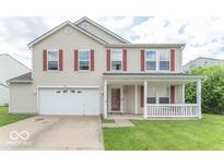 Charming two-story home featuring a covered front porch, red shutters, and a well-maintained lawn at 8712 Mellot Way, Camby, IN 46113