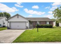 Charming single-story home featuring a brick facade, attached garage, and well-maintained lawn at 905 Congressional Way, Shelbyville, IN 46176