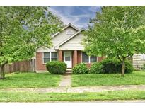 Charming brick home featuring a well-maintained front yard with mature trees and lush landscaping at 924 S B St, Elwood, IN 46036