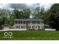 Charming two-story home with large front yard and mature trees at 9650 Copley Dr, Carmel, IN 46290