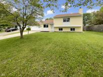 Charming two-story home with a well-manicured lawn and classic architectural details at 1464 Scarlett Ct, Franklin, IN 46131
