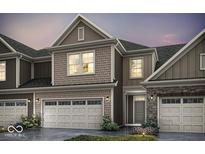 Charming home exterior boasts stone and siding accents, showcasing a welcoming facade and attached garages at 14866 E Keenan Cir # Lot 38, Westfield, IN 46074