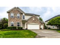 Charming two-story home with a brick and siding exterior, well-manicured lawn, and three-car garage at 16126 Etna Green, Westfield, IN 46074